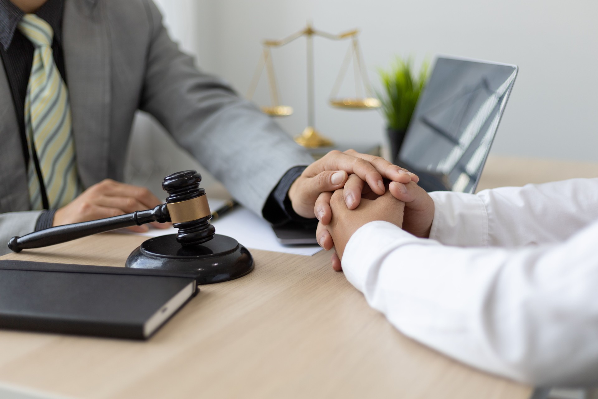 Justice and attorney concept. Lawyer meeting and consoling solution to his client provide legal advice and trust commitment strain serious for problem.